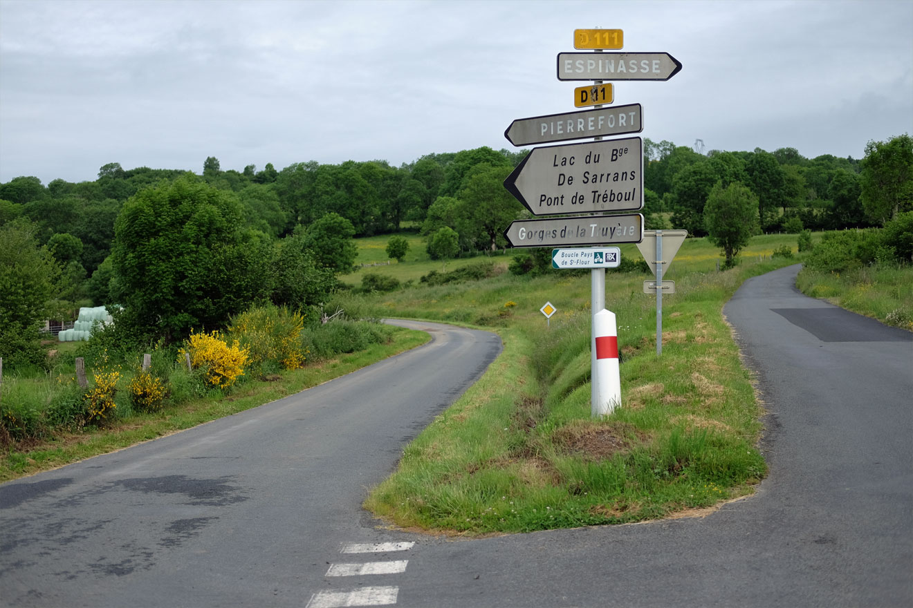 Straßeneinmündung in Frankreich mit Wegweiser